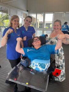 Three Townsville Community Information Centre volunteers with a TCIC member